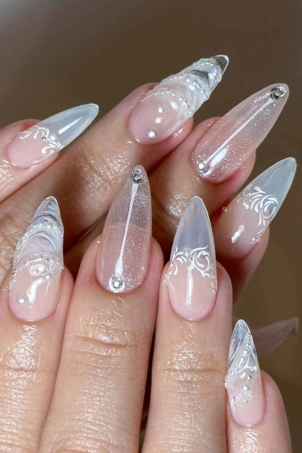 White lace pattern over a sheer nude base with pearl detailing; classic bridal nails with vintage charm.