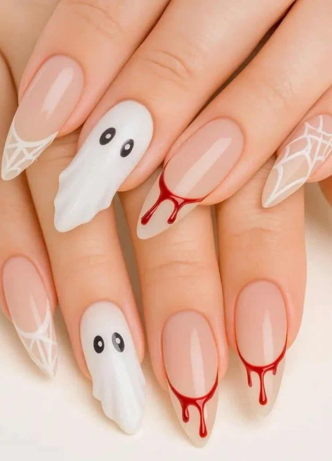 This design mixes cute ghost faces, spiderwebs, and bloody drips all in one set. It’s like three Halloween nail art styles had a spooky little baby, and it totally works.
